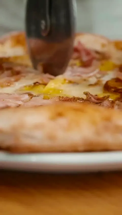 Pizza dough shaped by hand at Stone Milled